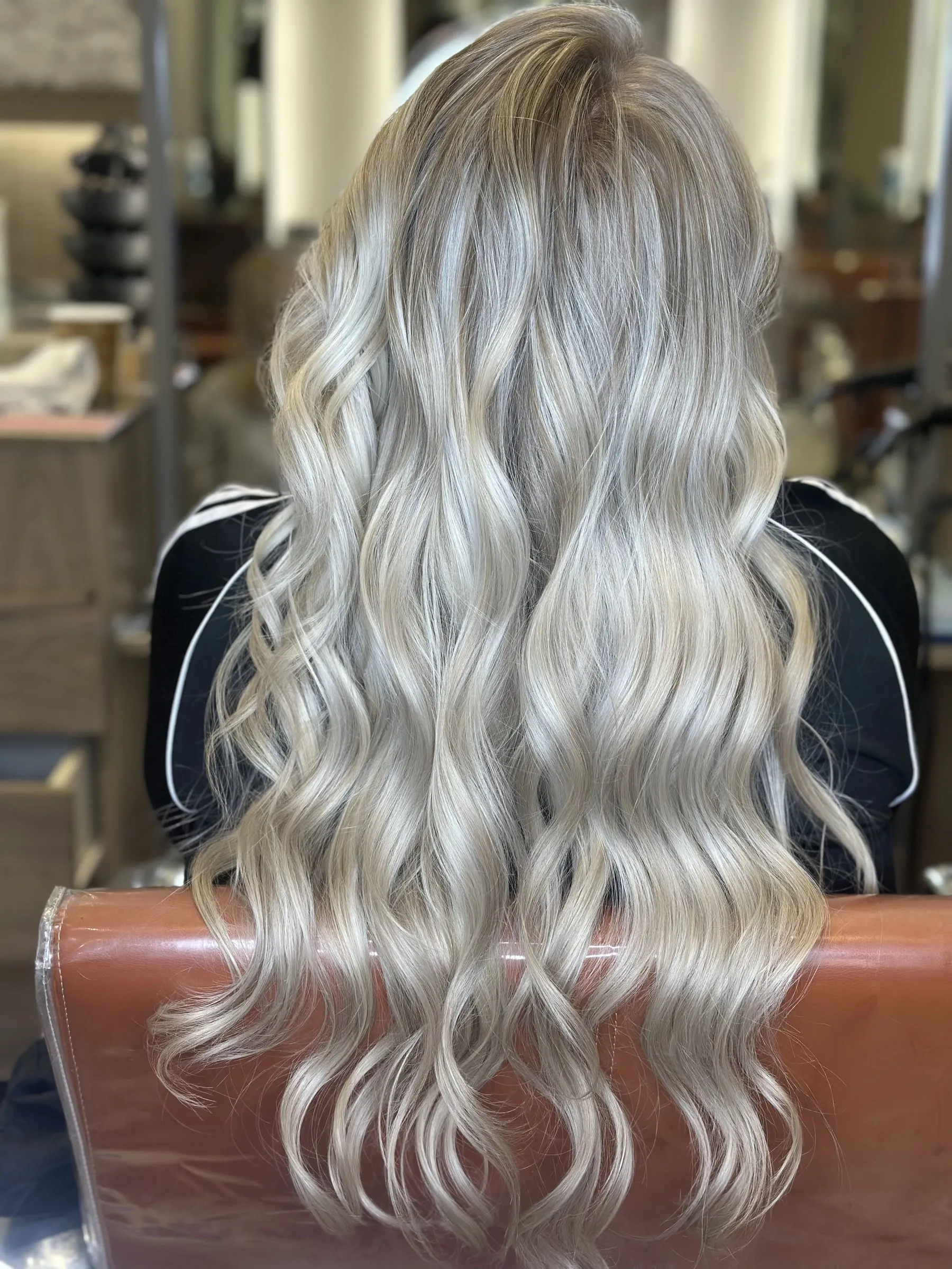 Silver ash blonde balayage on long waves by Ronak Hairstylist in Toronto