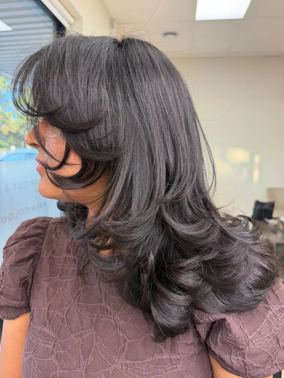 Long layered cut with curtain bangs and a soft blow-dry by Ronak Hairstylist in Toronto