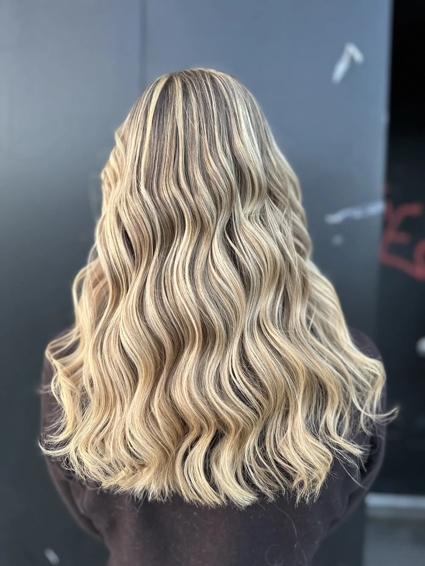 Bright blonde beach waves by Ronak Hairstylist in Toronto