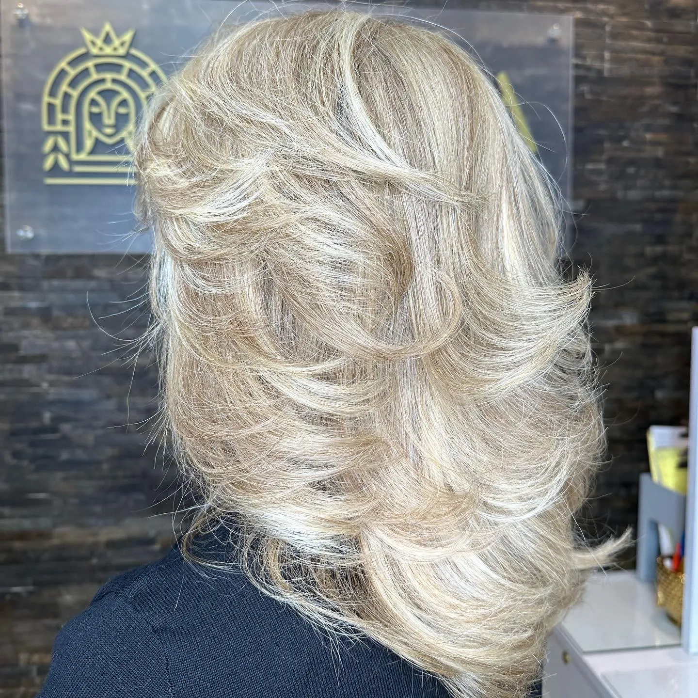 Feathered platinum blonde layers by Ronak Hairstylist in Toronto