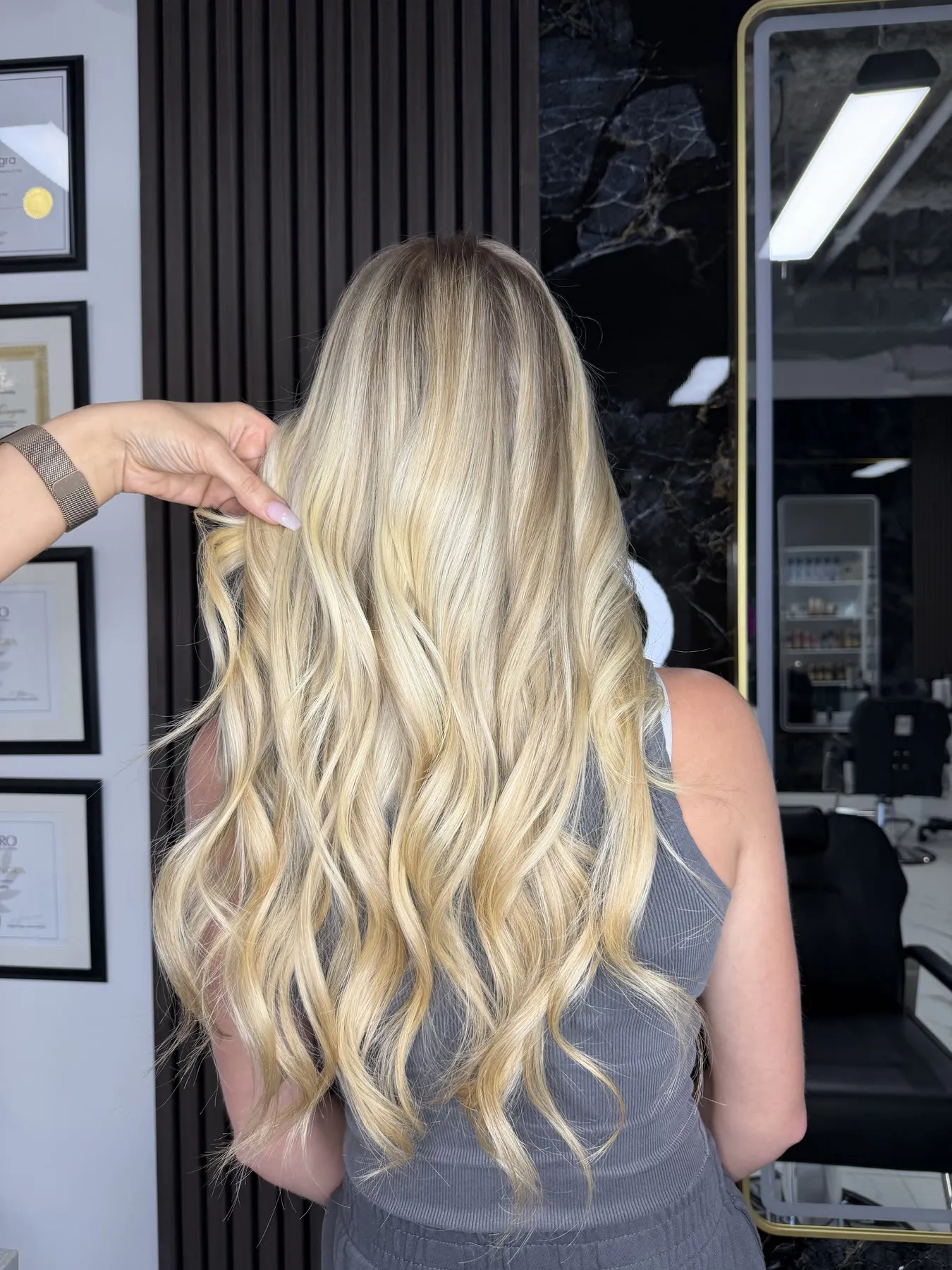 Bright golden blonde on long waves by Ronak Hairstylist in Toronto